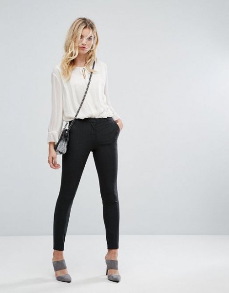 white chiffon semi sheer blouse with black joggers and gray heels