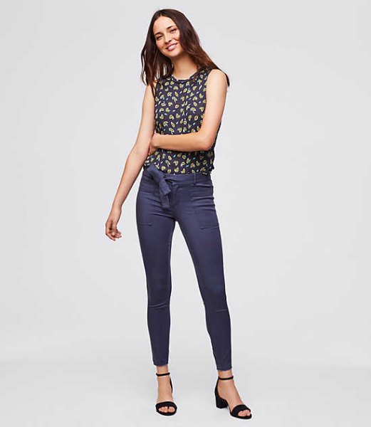 navy and red printed sleeveless blouse with blue chinos