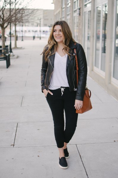 leather jacket with white v-shirt and black jogging jeans
