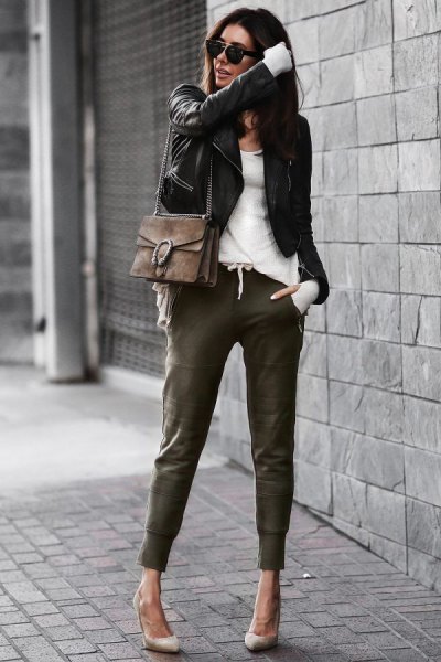 black leather jacket with white top and khaki joggers