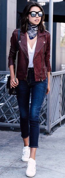 motorcycle jacket with white v-neck blouse and cropped jeans