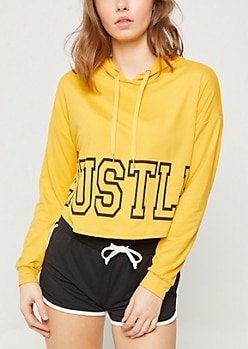 mustard printed hoodie with black mini-shorts