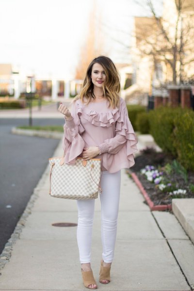 blush pink ruffle sleeve and neck shirt with white skinny jeans