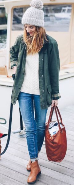 olive green jacket with white knitted sweater and ankle boots