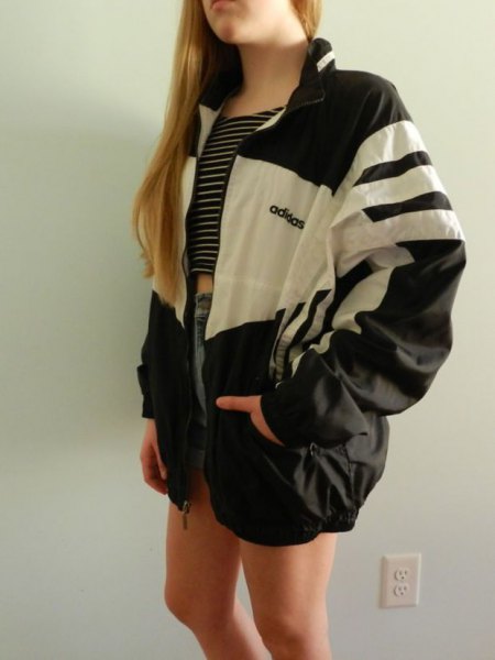 black and white nylon jacket with cropped tank top and denim shorts