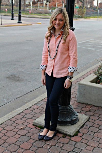 peach button up shirt over white and black polka dot blouse