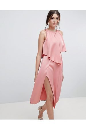 peach sleeveless blouse with matching high split midi skirt