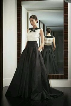 white sleeveless chiffon blouse with black floor length skirt