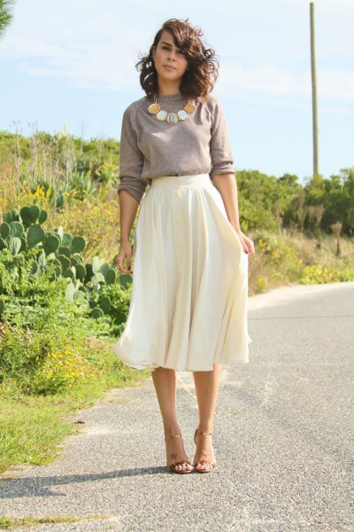 gray sweater with statement necklace with white midi floating skirt
