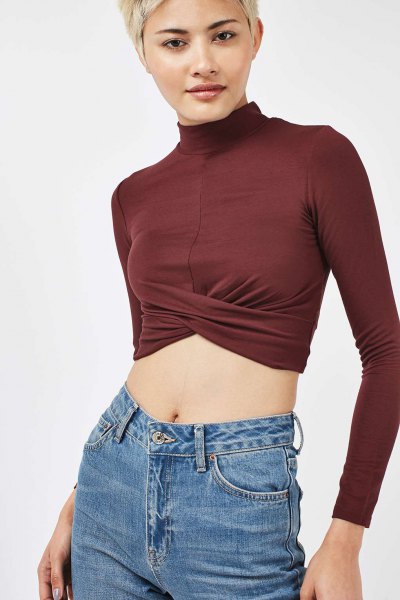 green top mock neck long sleeve top with blue jeans