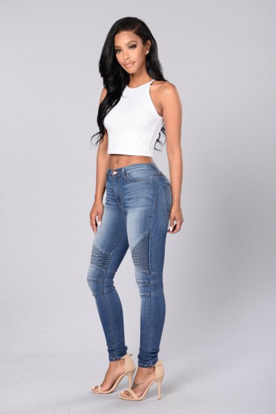 white cropped makeup top with blue washed moto jeans