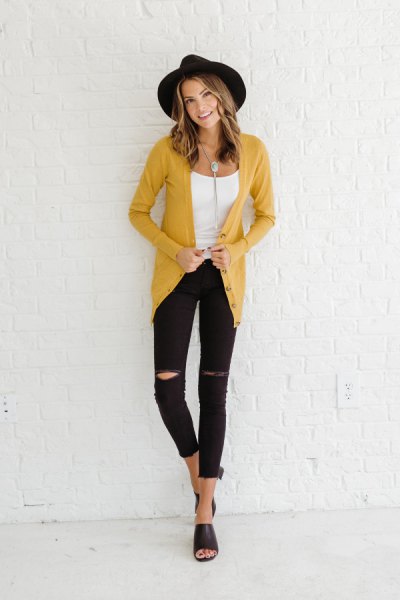 yellow cardigan with black felt hat and cropped slim jeans
