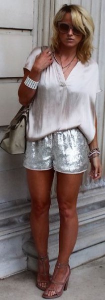white short-sleeved blouse with silver shorts in sequin