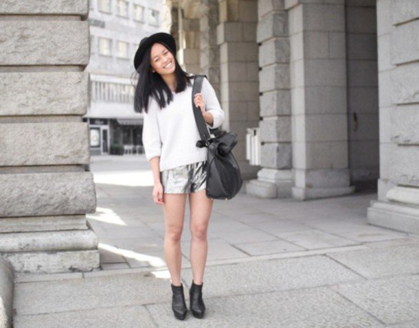 white half-warm knitted sweater with silver shorts and felt hat