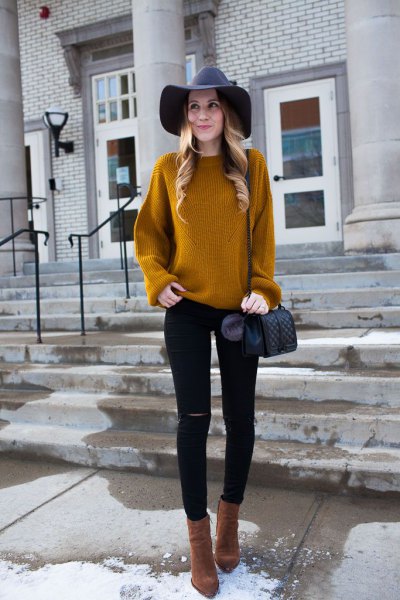 amber ribbed sweater with black floppy hat