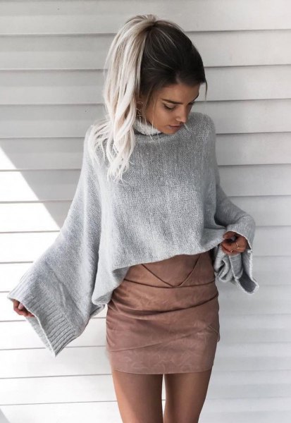 gray sweater with wide sleeve and matching matte leather skirt
