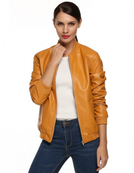 mustard leather bomber jacket with dark blue jeans
