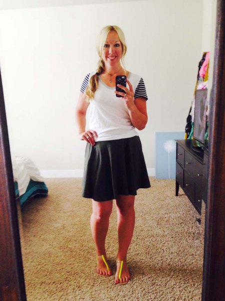 black skater skirt and white shirt neck t-shirt with striped sleeves
