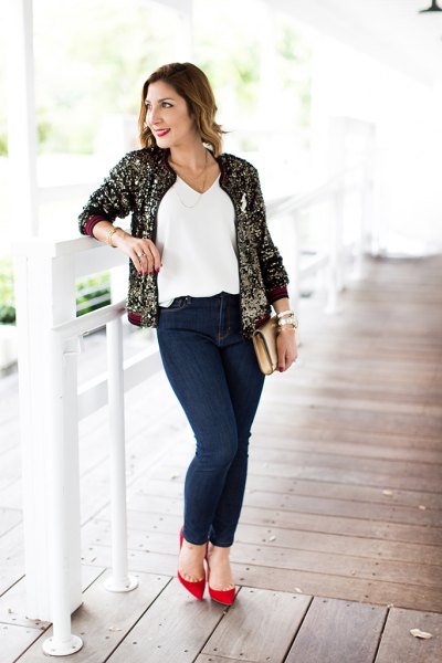 gold and black sequin bomber jacket with white v-top and jeans