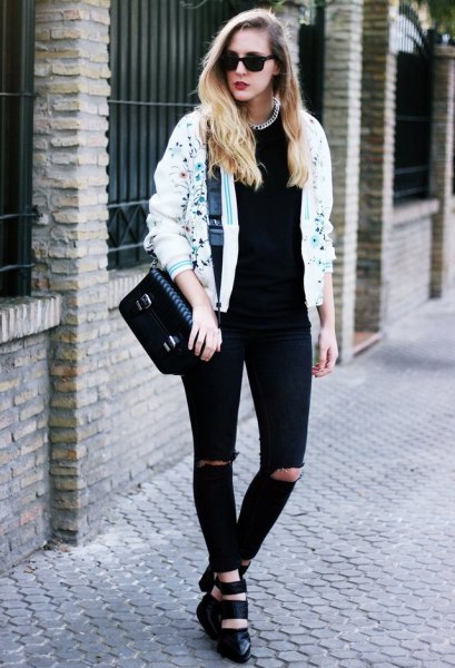 white print bomber jacket and black ripped jeans