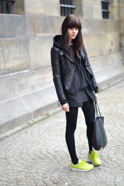 black leather jacket with gray mini skirt and yellow sneakers