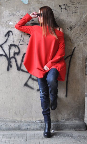 red long sleeve one shoulder top with dark blue skinny jeans