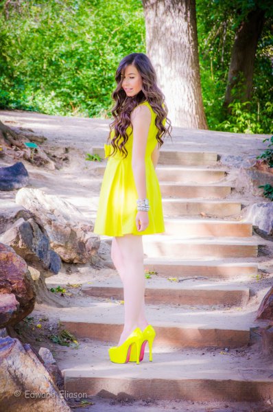 yellow sleeveless flared mini dress with matching high heels