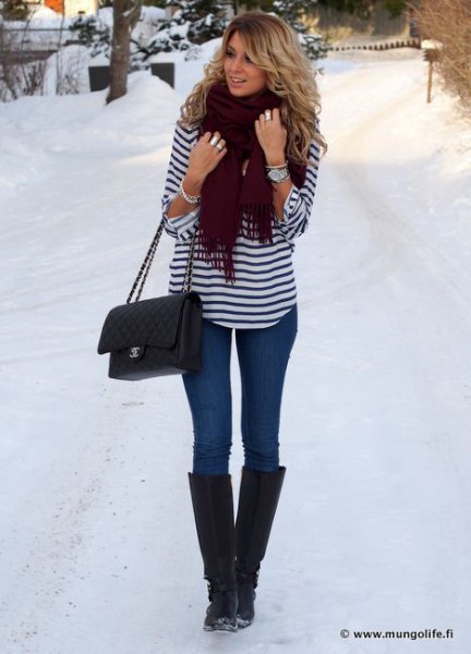 black and white striped long sleeve tee with blue jeans and snow boots