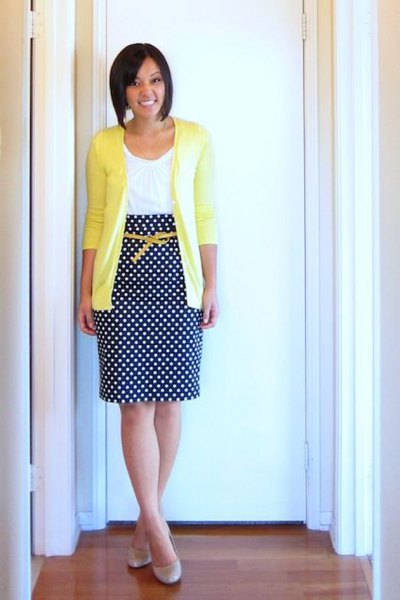 yellow cardigan with white vest top and midi skirt with polka dot