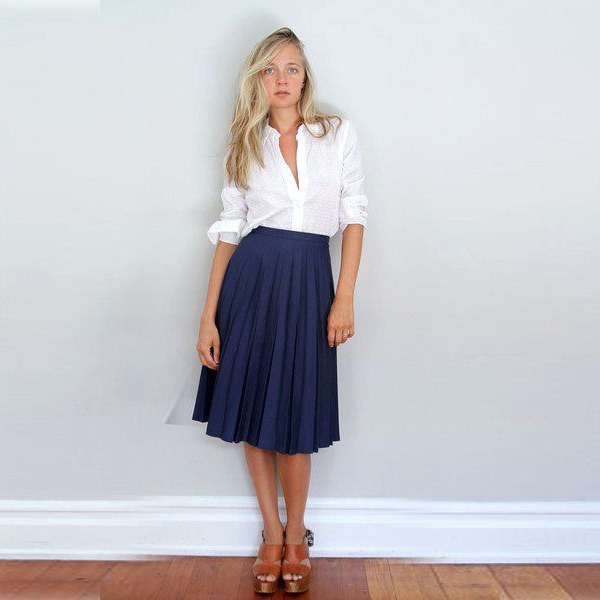 white button up shirt with navy midi pleated skirt