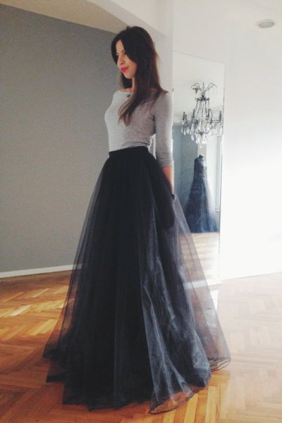 gray form fitting top with black floor length tutu dress
