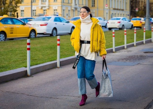 yellow jacket with black turtleneck chunky sweater and jeans with wide leg