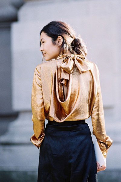 golden silk blouse with black midi skirt