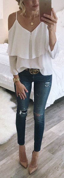 ruffle top with skinny ankle jeans and statement belt