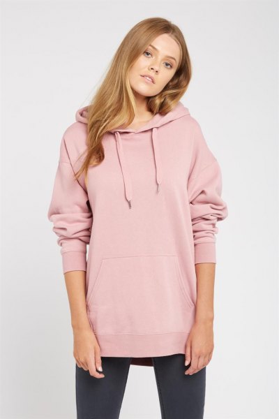 light pink long-sleeved hooded jacket with black leggings and sneakers
