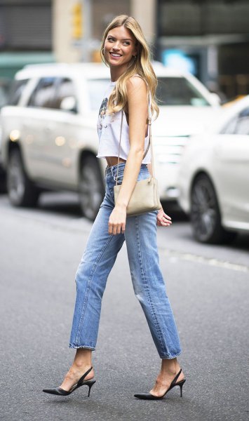 white sleeveless crop top with blue jeans with straight legs