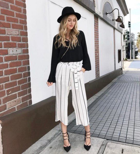 black sweater with white cropped trousers