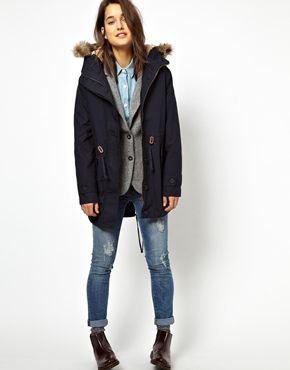 navy fur lined parka rock with gray vest and jeans