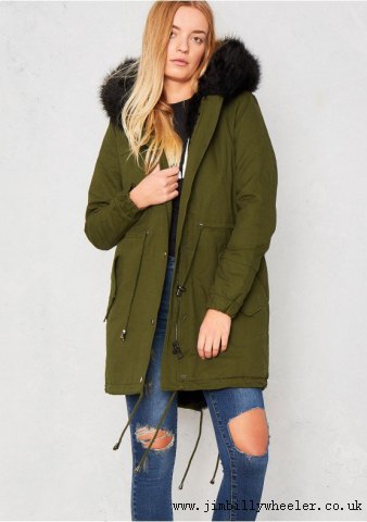 brown fur lined parka with ripped jeans