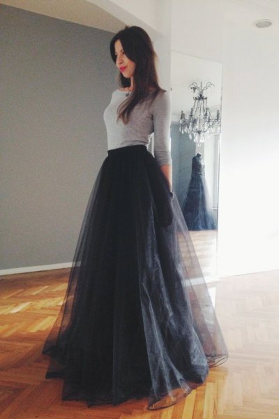 gray form fitting sweater with black long tulle-extended skirt