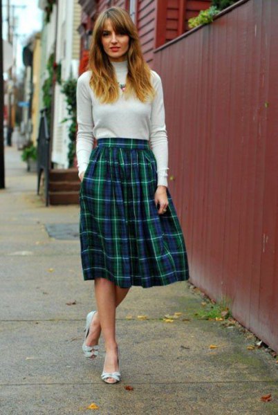 sweater with elastic mock neck with midi-pleated plaid skirt