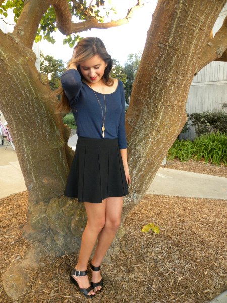 dark blue fitted long sleeve t-shirt with black mini circle skirt