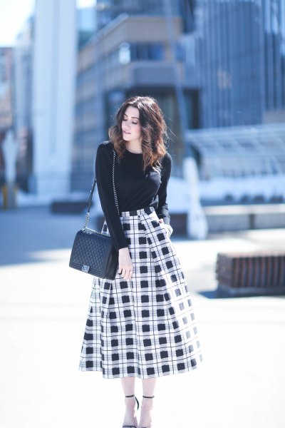black sweater with crew neck with waist colored plaid skirt with high waist