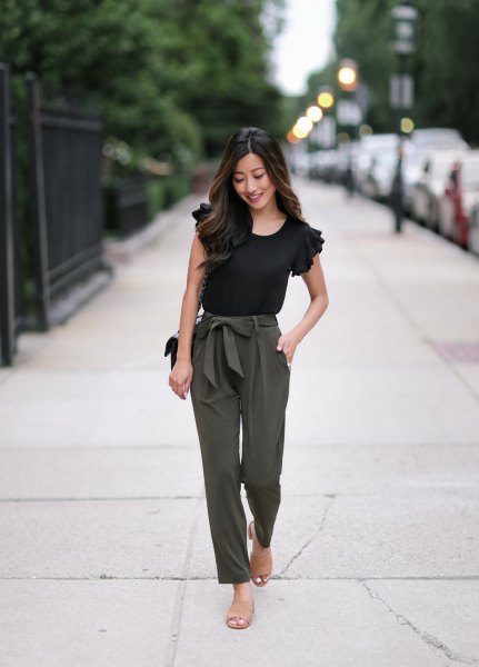 black ruffle tee with green tie at waist with straight leg