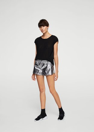 black t-shirt with silver shorts and sneakers