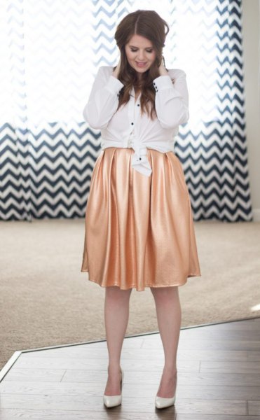 white knotted button up shirt with pink silk pleated skirt