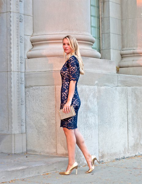 navy lace dress with light pink clutch bag
