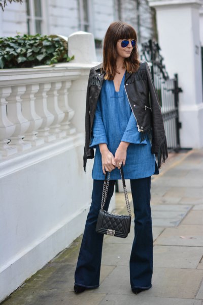 blue v-neck tunic with black leather jacket and flared jeans