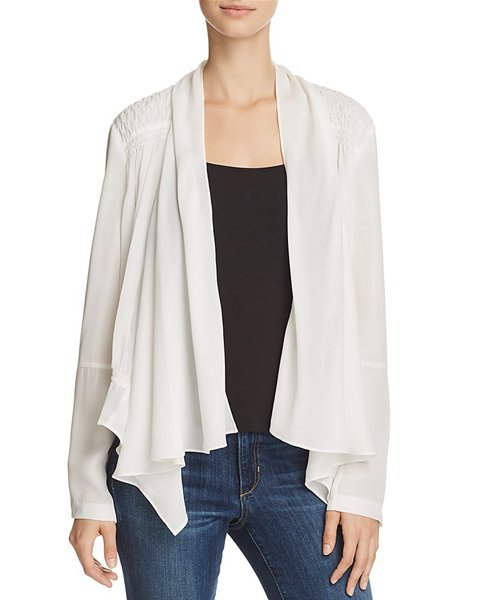 white silk jacket with black waistcoat and blue skinny jeans