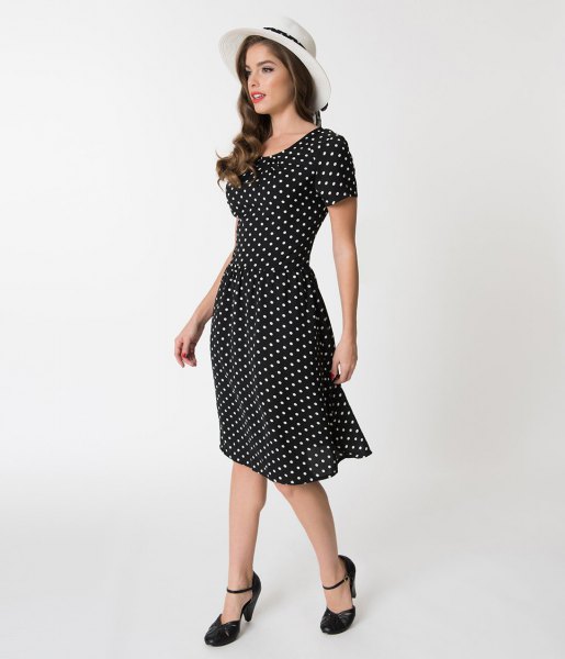 black and white spotted dress with white felt hat